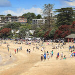 Hundreds of holiday makers gathered at Mission Bay and other beaches around Auckland on Christmas Day to celebrate with friends and family. 25 December 2011 New Zealand Herald Photograph by Greg Bowker